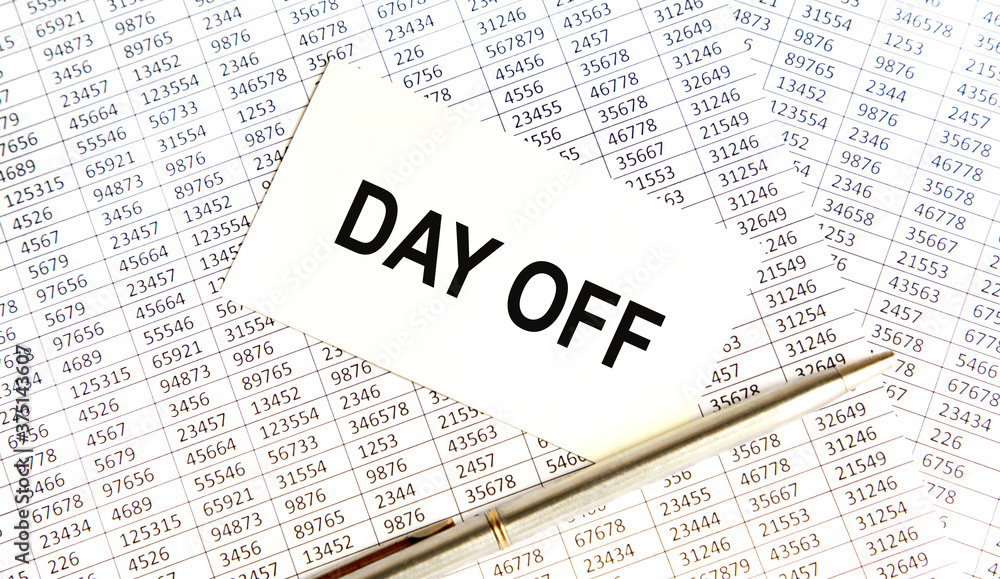 Inscription on the card DAY OFF, against the background of the report and pen. Inscription on the card DAY OFF, against the background of the report and pen.