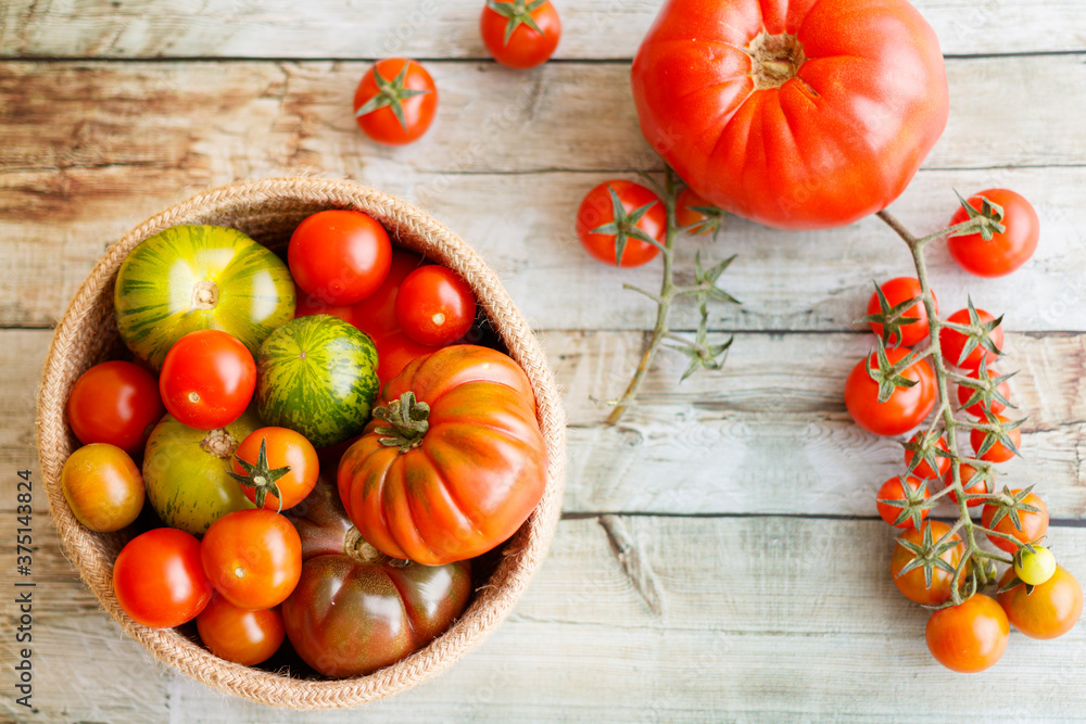 Basket with a variety of tomatoes, including: Cherry, Heirloom and Zebra Basket with a variety of tomatoes, including: Cherry, Heirloom and Zebra