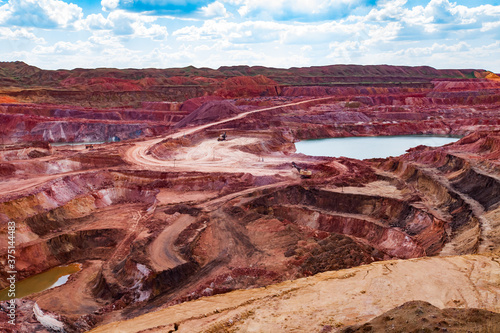 Obraz na plátně Aluminium ore quarry and blue lake in bauxite mine