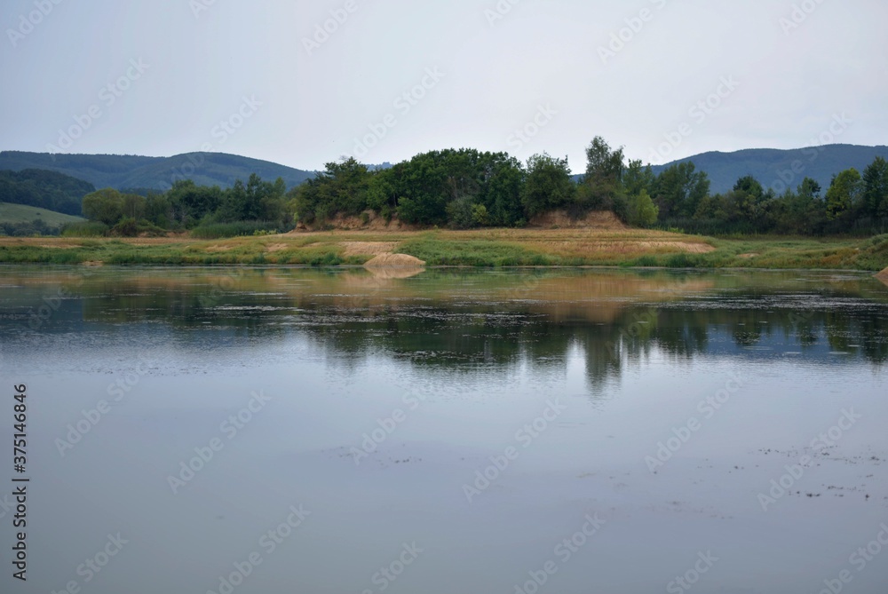 landscape before the storm with gray sky and lake