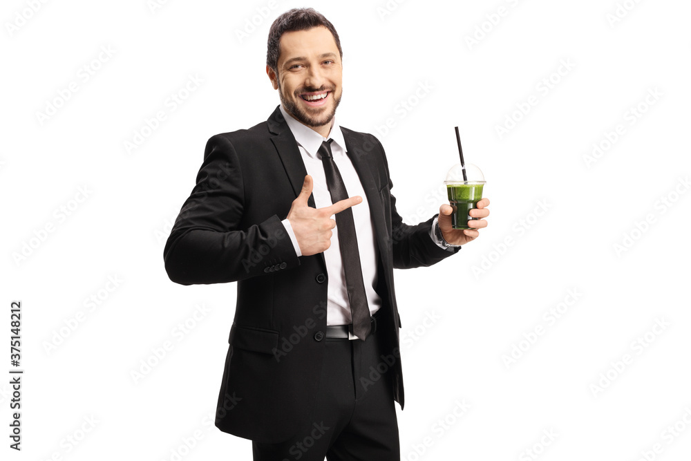 Smiling professional man in a suit showing a healthy green smoothie in his hand Smiling professional man in a suit showing a healthy green smoothie in his hand