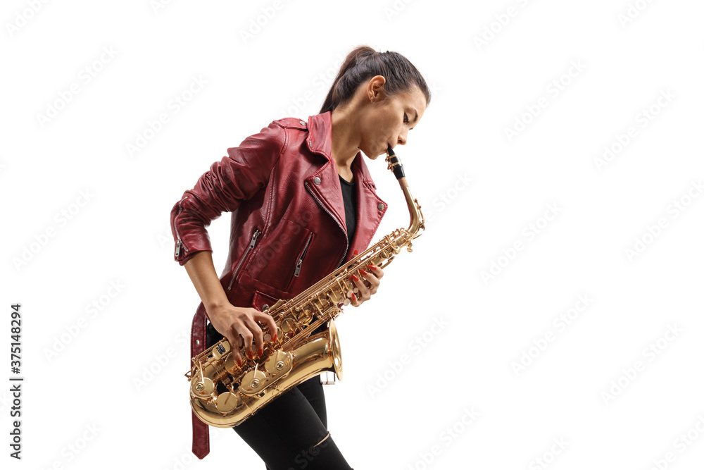 Naklejka premium Young female musician in a leather jacket playing a saxophone
