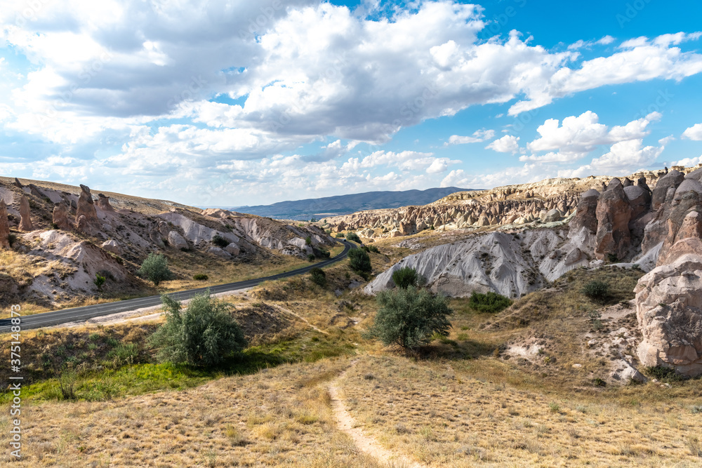 Road and rock fromations at Cappadocia, near Nevsehir city, Turkey