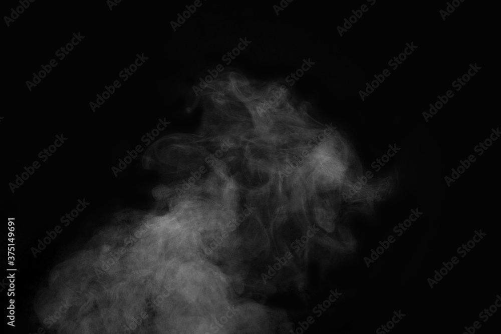Curly smoke, steam, isolated on a black background. The smoke looks like a ghost. Can be used as abstract background