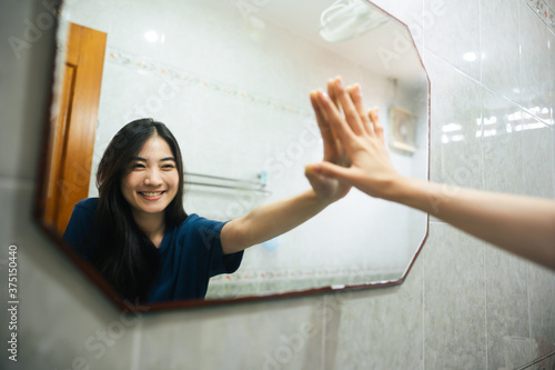 Fotografi Young adult smile asian woman practice self talk conversation with mirror in the