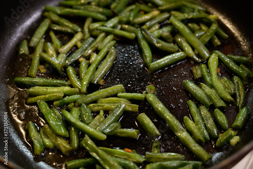 Fried beans in pods a pan. Seelctive focus. photo