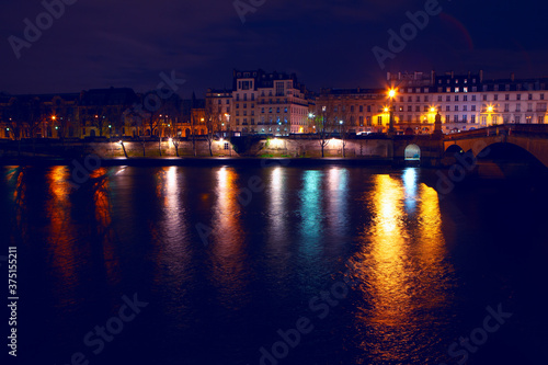 Paris and Seine riverside in the night . Pont du Carrousel illuminated in the night 