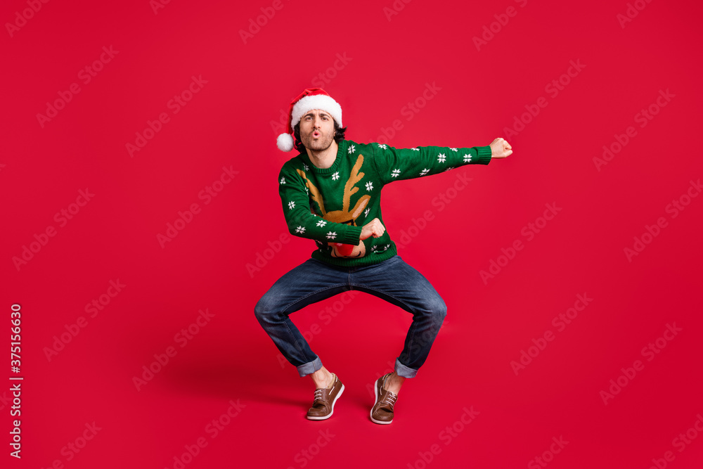 Full length body size view of his he nice attractive childish glad cheerful guy wearing Santa cap dancing having fun newyear festive fooling isolated bright vivid shine vibrant red color background Full length body size view of his he nice attractive childish glad cheerful guy wearing Santa cap dancing having fun newyear festive fooling isolated bright vivid shine vibrant red color background