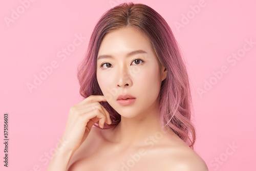 Beautiful Young asian Woman with Clean Fresh Skin, on Pink background, Face care, Facial treatment. Cosmetology, beauty and spa. Asian women portrait