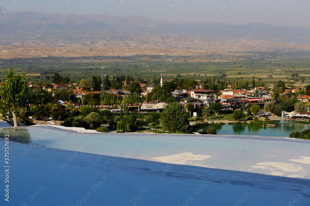 Obraz premium View of the beautiful Pamukkale Travertine pools, known as Cotton castle, at Hierapolis Pamukkale world heritage site in the city of Denizli, Turkey.