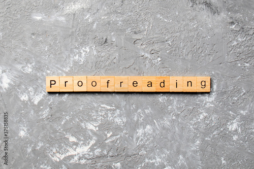 proofreading word written on wood block. proofreading text on table, concept