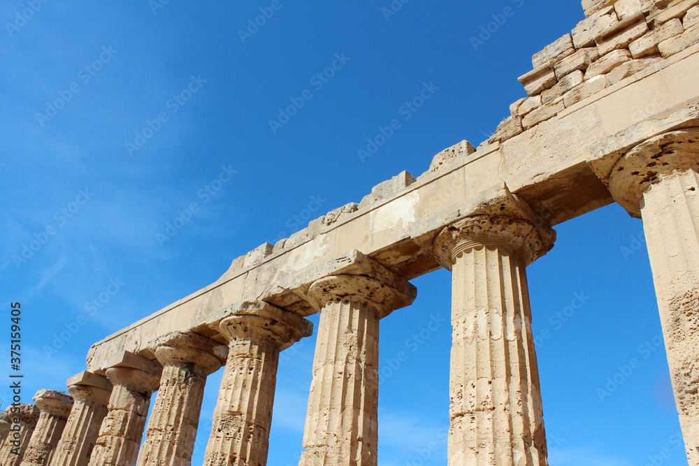 Ancient temple's columns with sky in background