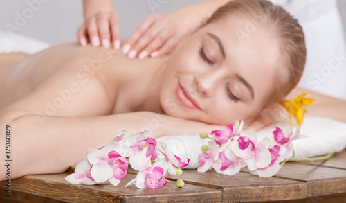 Pleasure of spa treatments. Female hands do relaxing massage for woman with closed eyes