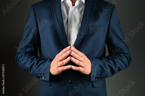 Man in suit with folded fingers