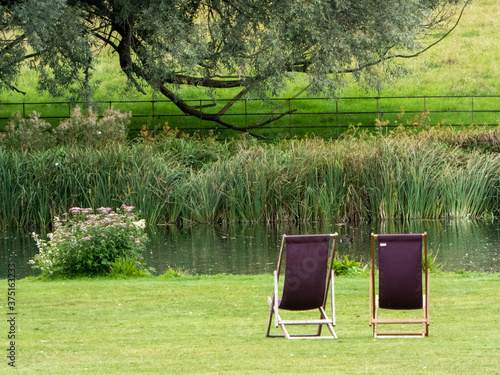 Two deckchairs to relax in by the river bank, a typical British countryside scene