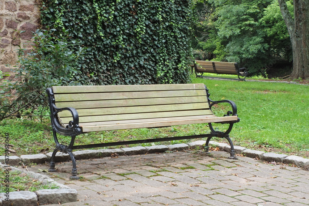 The bench is located in quiet part of the park.