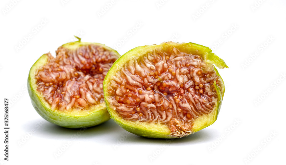 half fig, macro shot on white background shows the juicy red fruit pulp with the seeds.