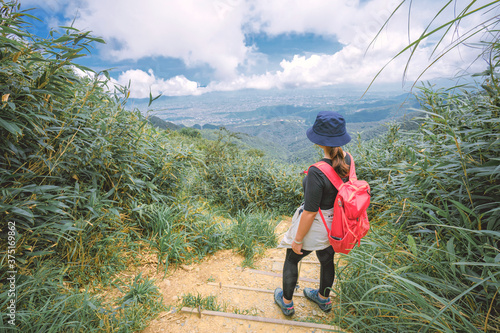 Ilan County, Taiwan - August 7th, 2020: A young female is walking on the famous Marian Hiking Trail, which is located above the Wufengqi Waterfall Scenic Area in Jiaoxi Township, Yilan County.