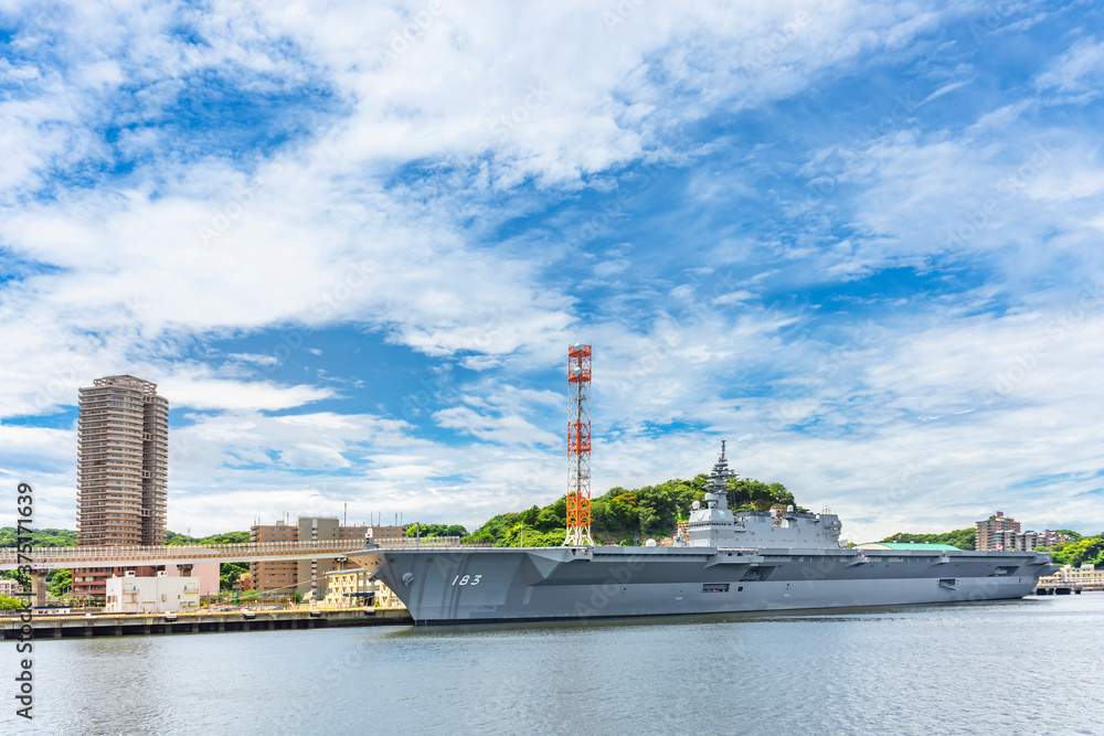 yokosuka, japan - july 19 2020: Wide angle view of the Japanese Destroyer JS Izumo DDH-183, an helicopter and aircraft carrier of Japan Maritime Self-Defense Forces berthed in the Yokosuka naval port.