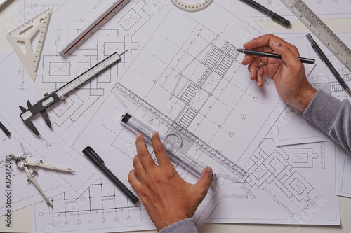 Architect engineer contractor design working drawing sketch plan blueprint and making architectural construction house building in architect studio.