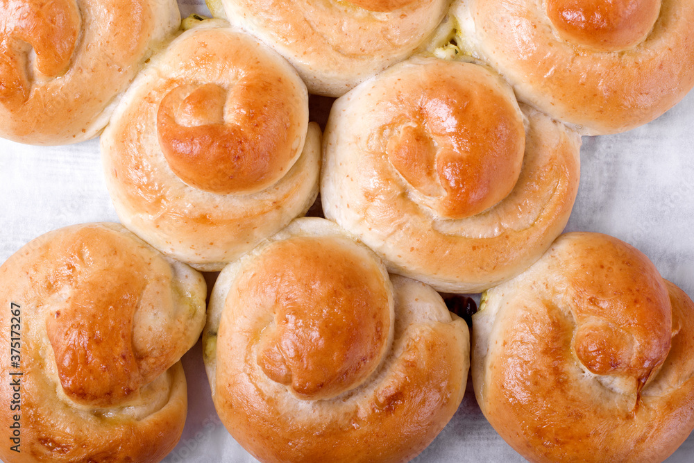 Yeast buns with filling on the parchment paper Yeast buns with filling on the parchment paper