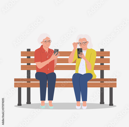 Elderly women are sitting on the bench with smartphones. Vector flat cartoon style illustration