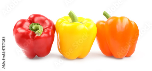 Fresh ripe bell peppers on white background