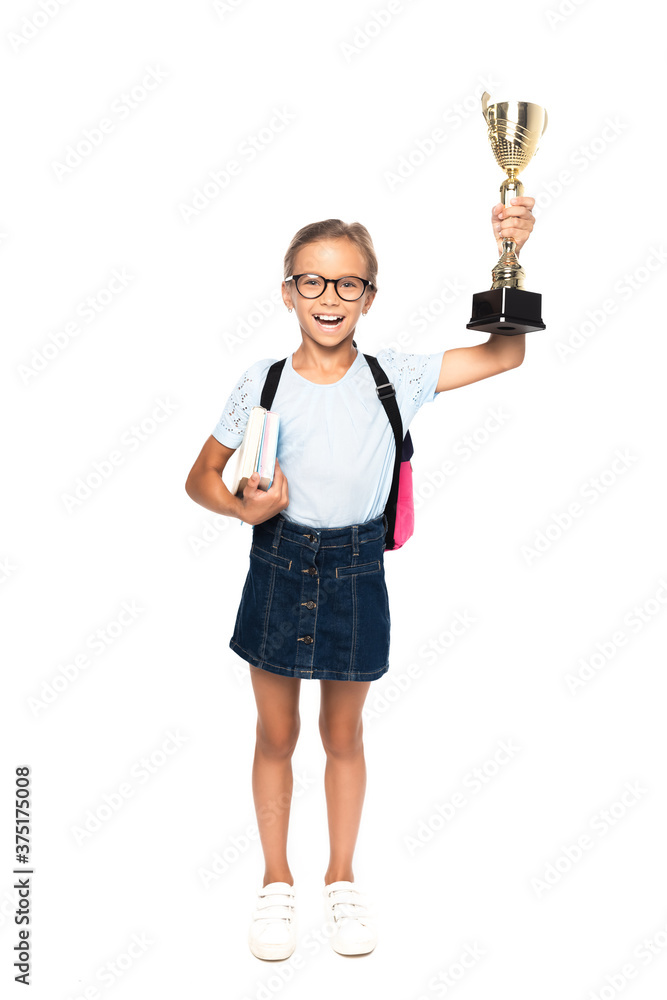 excited schoolgirl in glasses holding books and golden trophy isolated on white excited schoolgirl in glasses holding books and golden trophy isolated on white