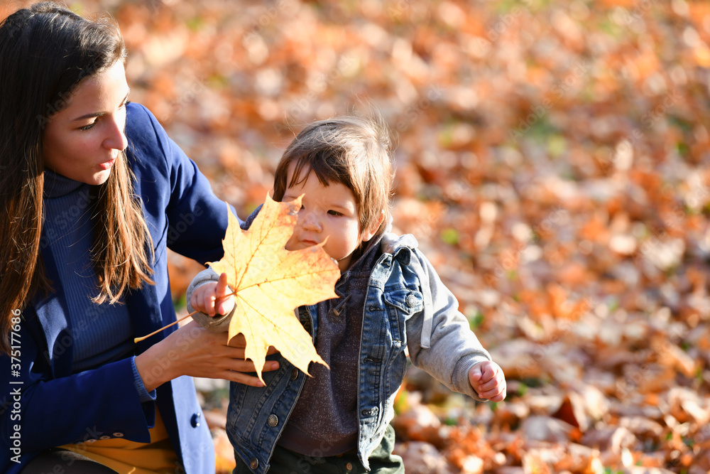Young mother with child spend time in autumn park Young mother with child spend time in autumn park