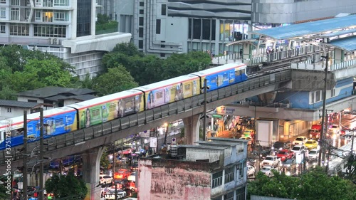 On Nut, Bangkok - 20 August 2020: Traffic drives through Sukhumvit Road. Cars, skytrains and people walking on Sukhumvit On Nut Road on a rainy day, Bangkok.