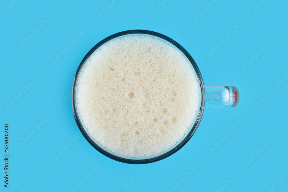 Delicious homemade kvass in glass mug on light blue background, top view Delicious homemade kvass in glass mug on light blue background, top view