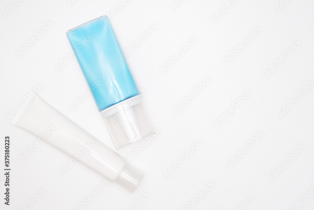 Two bottles of cream, lotion for sensitive skin, body care products isolated on white background with copy space Two bottles of cream, lotion for sensitive skin, body care products isolated on white background with copy space