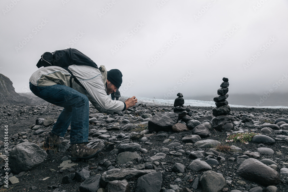 Travel Photographer Taking a Mobile Phone Photo of Stacked Zen Stones Travel Photographer Taking a Mobile Phone Photo of Stacked Zen Stones