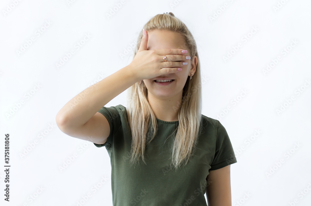girl with blond hair covering her eyes with one hand, isolated on white background girl with blond hair covering her eyes with one hand, isolated on white background