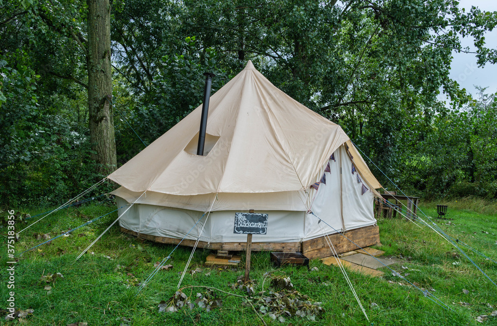 A fabric bell tent in the woods A fabric bell tent in the woods