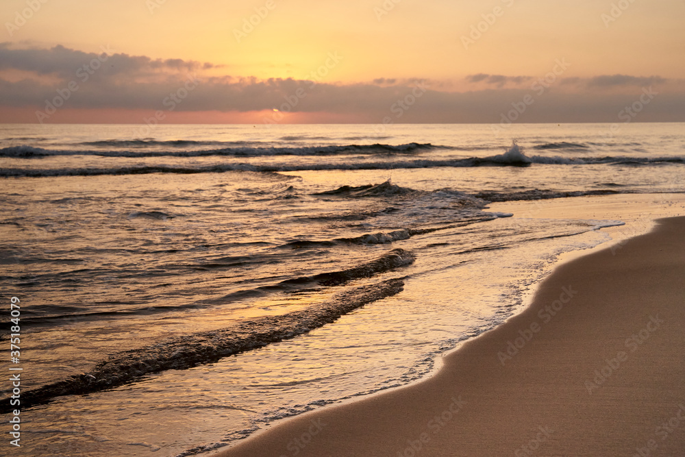 sunrise on the beach with the sea calm