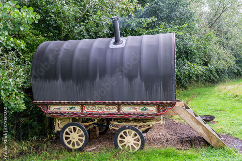 A gypsy caravan on wheels with smoke coming out of the chimney © iammattdoran