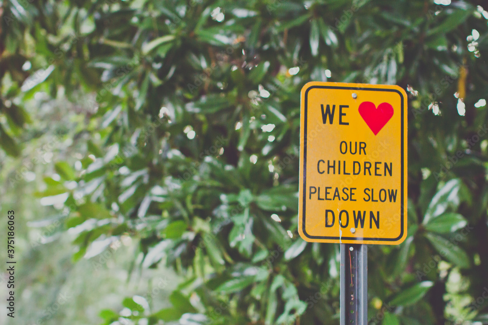 traffic sign that reads we love our children please slow down traffic sign that reads we love our children please slow down