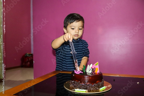 Indian cute kid cutting cake