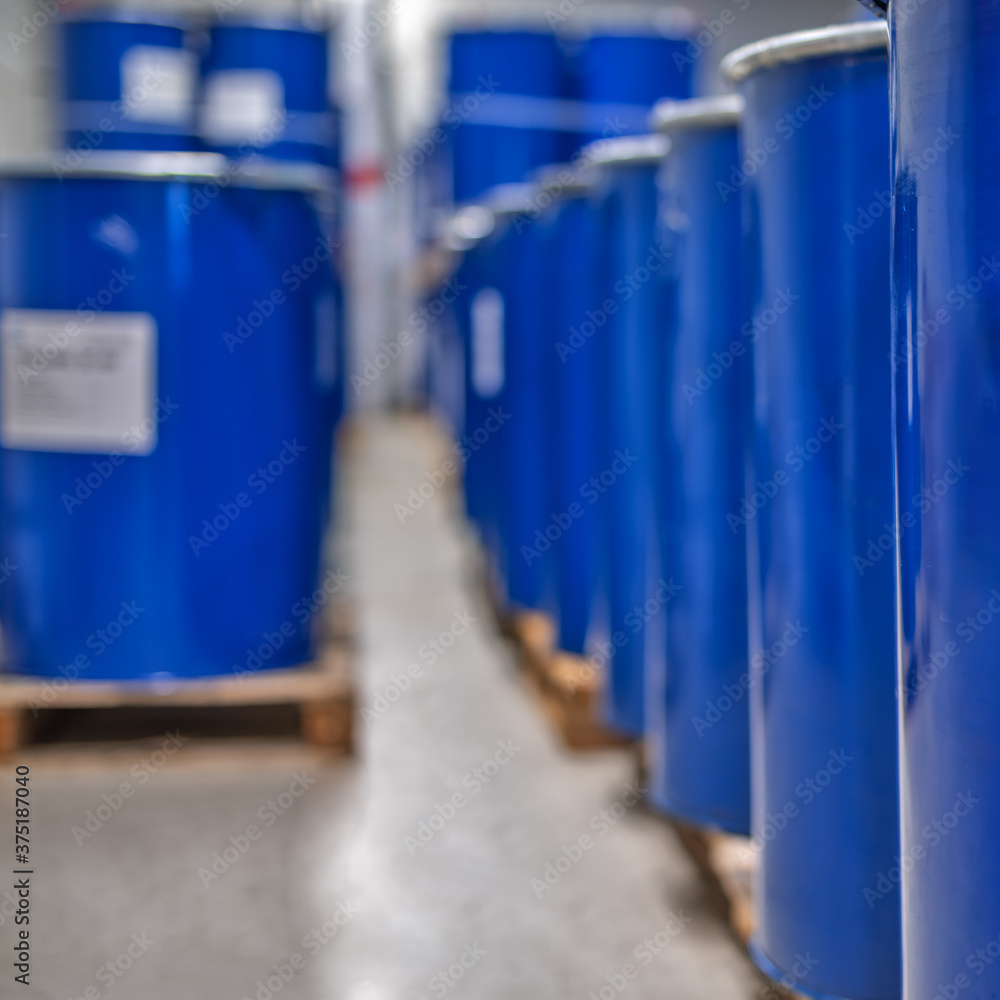 Chemical industry, paint and varnish production . Metal barrels for chemicals. Barrels are stored in a warehouse.