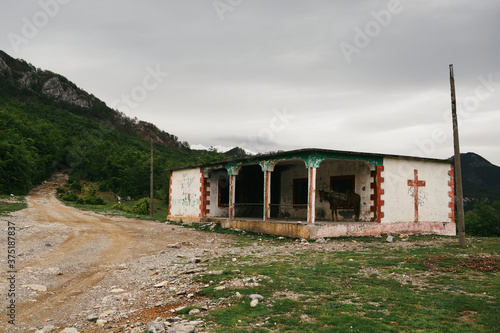 Ruin next to a unpaved road on a pass in Albania photo