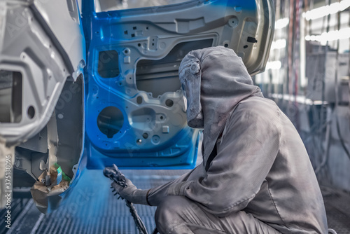 employee body painting workshop carries out painting of the internal elements of the car.