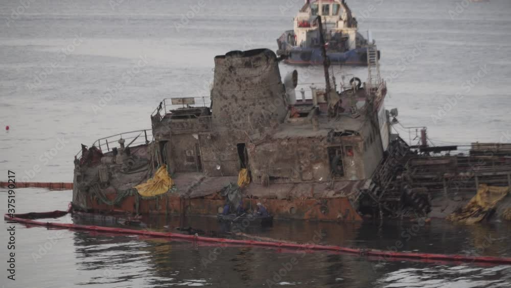 Industrial ship crane lifts old sunken tanker Delfi from Black Sea in Odessa, Ukraine 26 August 2020. Ship crashed near shore sea. Cargo tanker. Ecological disaster oil spill products. Tanker Delphi Industrial ship crane lifts old sunken tanker Delfi from Black Sea in Odessa, Ukraine 26 August 2020. Ship crashed near shore sea. Cargo tanker. Ecological disaster oil spill products. Tanker Delphi