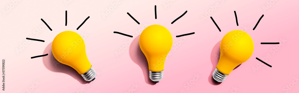 Three yellow light bulbs - flat lay from above - obrazy, fototapety, plakaty 