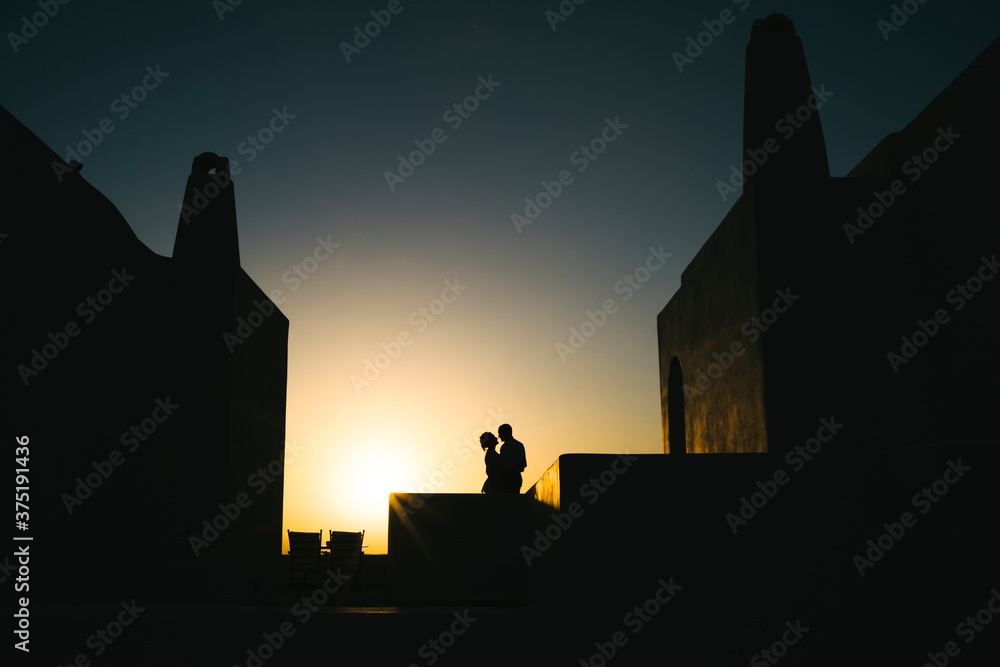 Affectionate couple against sunset Affectionate couple against sunset