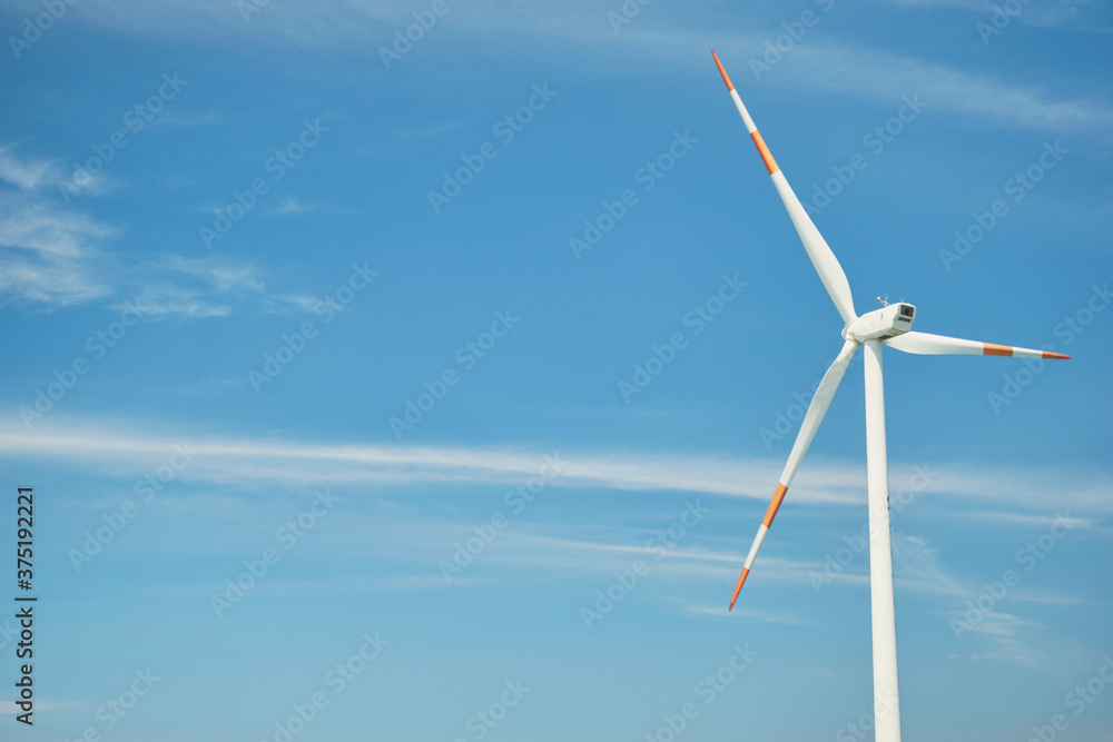 Blue sky wind turbine. Nature and eco-friendly energy.