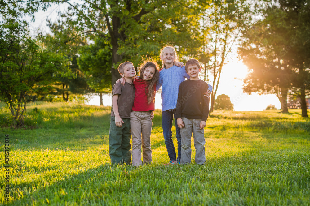 Children: Group of Friends in Backyard at Sunset Children: Group of Friends in Backyard at Sunset