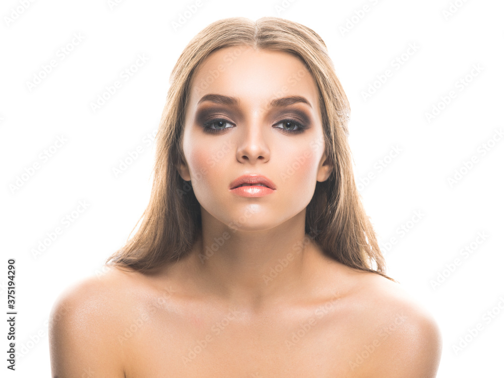 Young beautiful female model with heavy professional makeup looking at camera seductively isolated on white. Young beautiful female model with heavy professional makeup looking at camera seductively isolated on white.