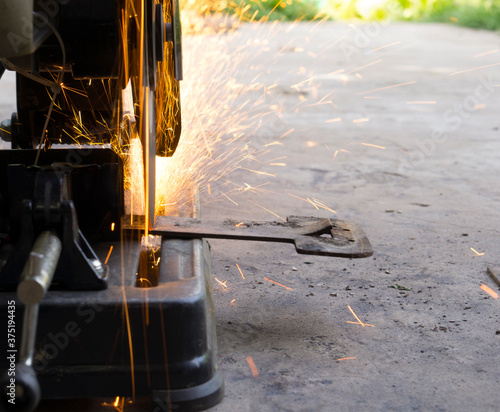 Sparks produced by the cut-off wheel when cutting metal.