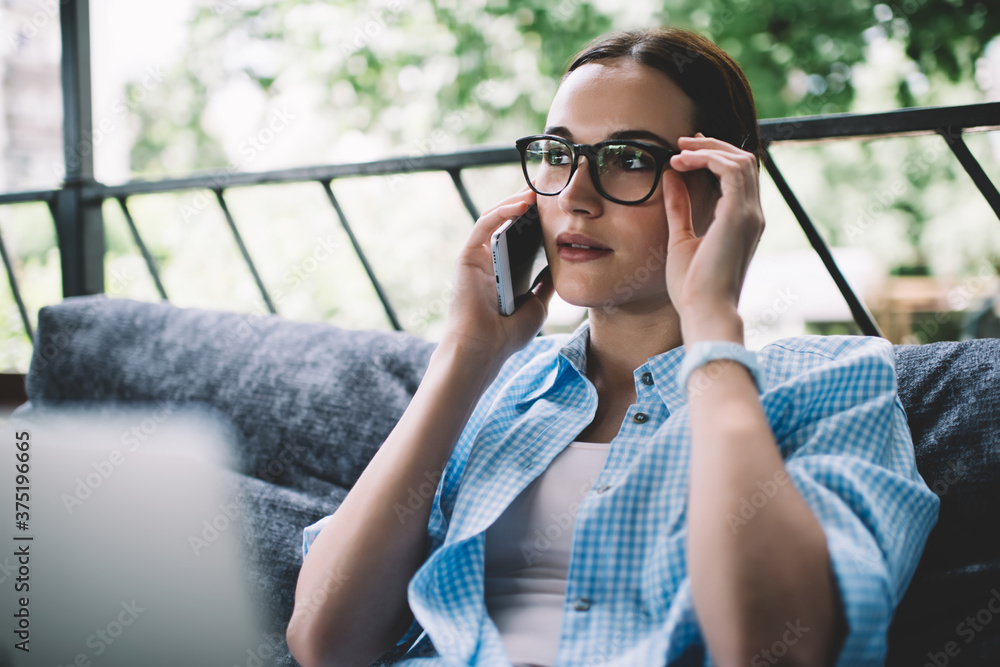 Serious adult freelancer having phone conversation on terrace Serious adult freelancer having phone conversation on terrace